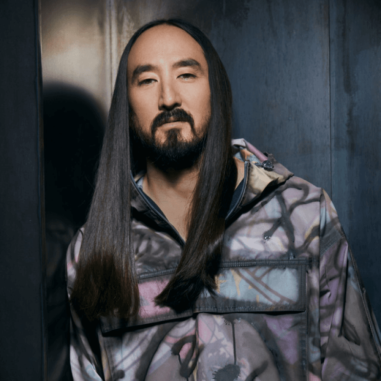 Artist portrait with long dark hair in a painted camo jacket